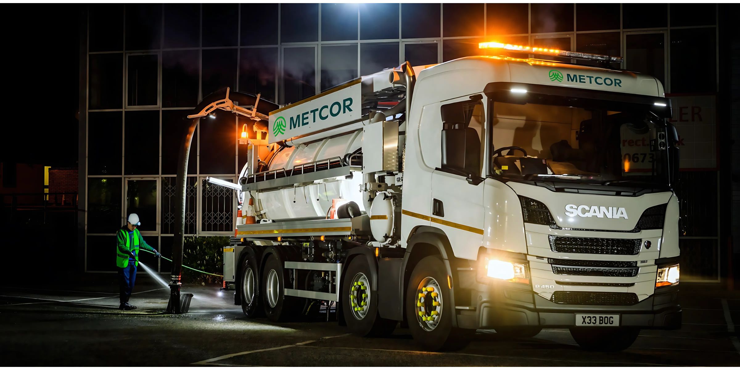 Metcor Tanker and engineer at night in front of office block